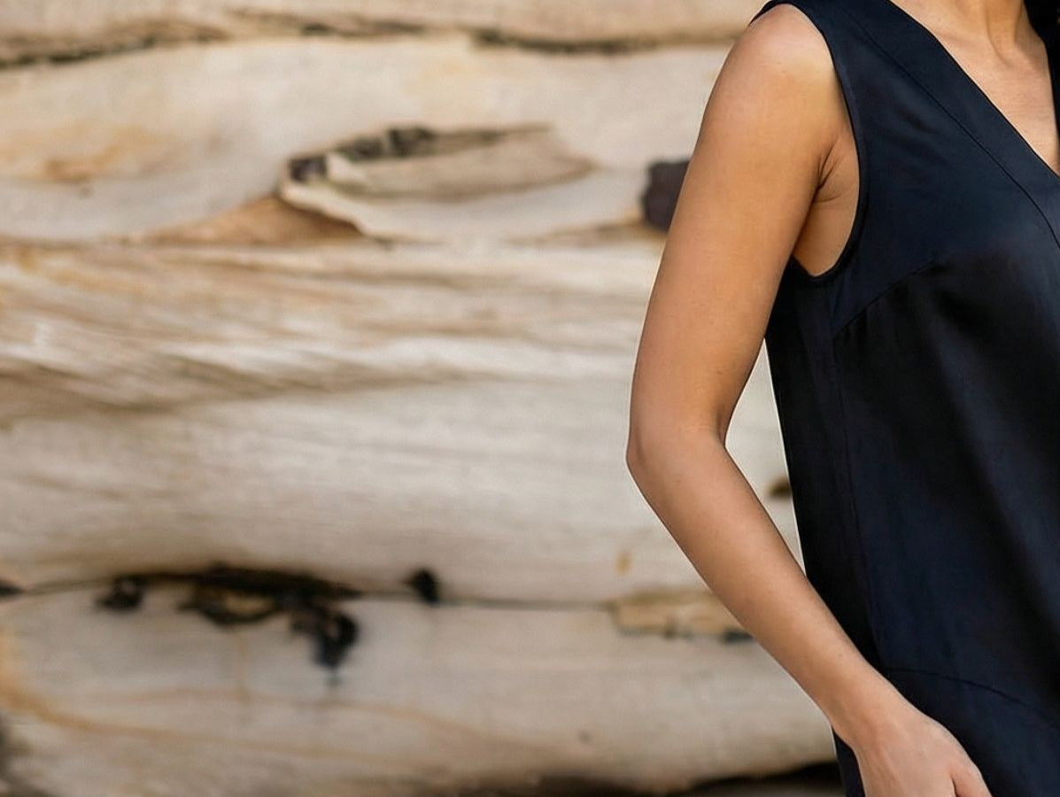 woman on beach wearing black cupro dress