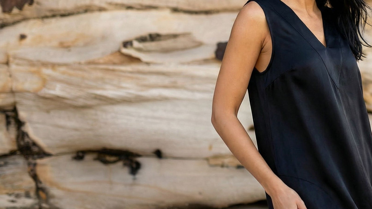 woman on beach wearing black cupro dress