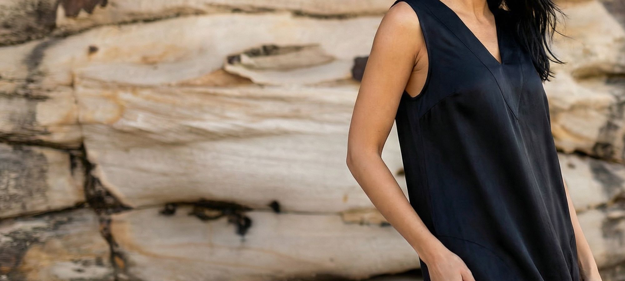 woman on beach wearing black cupro dress